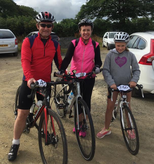 A proud Chris in his cycle trio with Karen and Hope