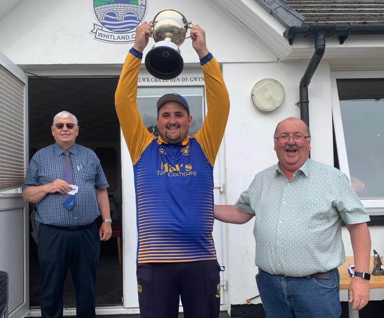 Proud Dock skipper George Smith raises the trophy