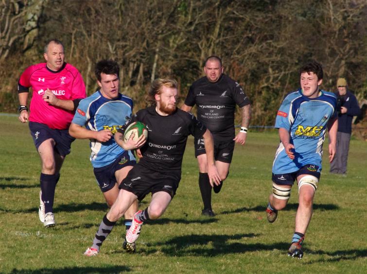 Scrum half Adam Cawley breaks for Neyland against The Saints