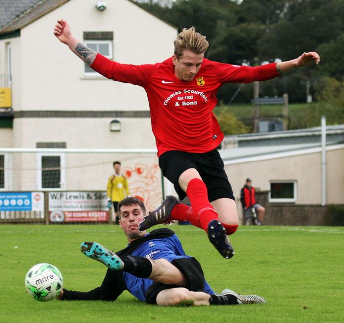 Milford Athletic clear their lines as Ian Darbyshire attempts to break for Carew. Picture by Susan McKehon