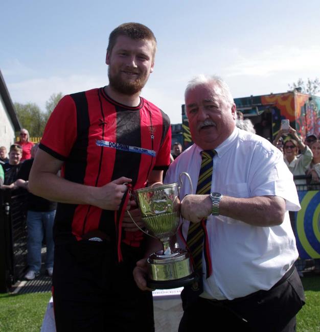Goodwick captain Scott Delaney receives the Senior Cup from Mackie Harts