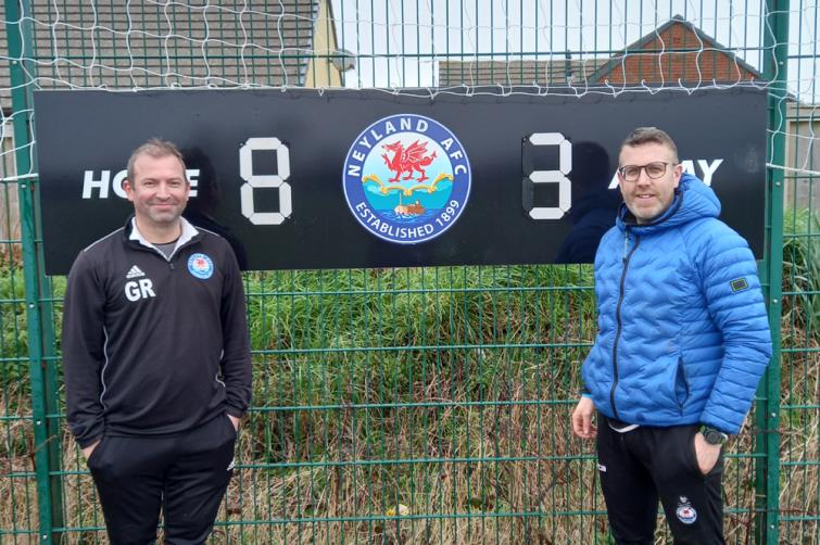 What is the score - Gavin Rowland and Jarred Campbell pose at the scoreboard