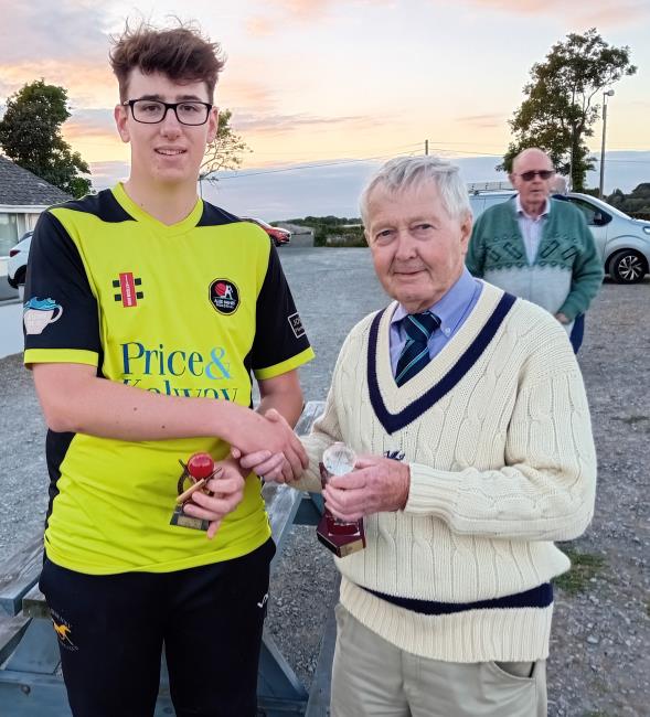 Oscar Lewis receives the MoM trophy from Nick Evans