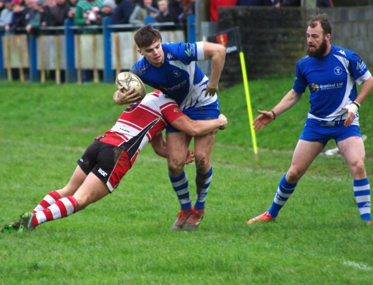 Mariners scrum half Dan McClelland puts a crunching tackle on Blues Liam Manwaring