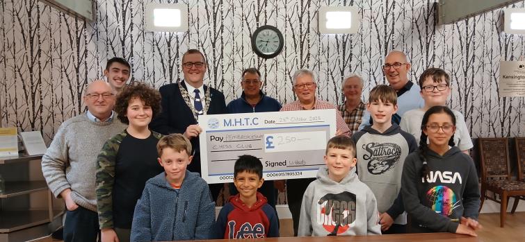 Pictured is William Elliott, presenting the cheque to some of our junior and senior members