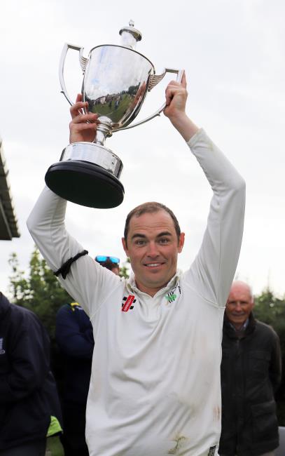 A delighted Sean Hannon raises the trophy aloft