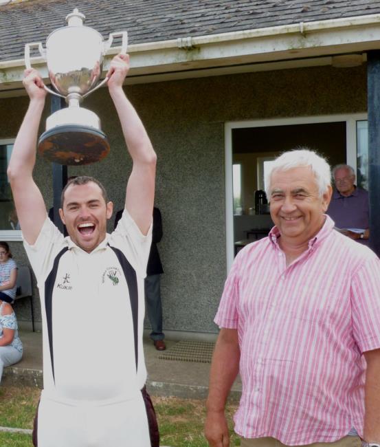 Sean Hannon raises the trophy