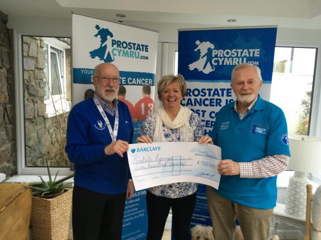 Charles Davies handing over a cheque to Prostate Cymru 